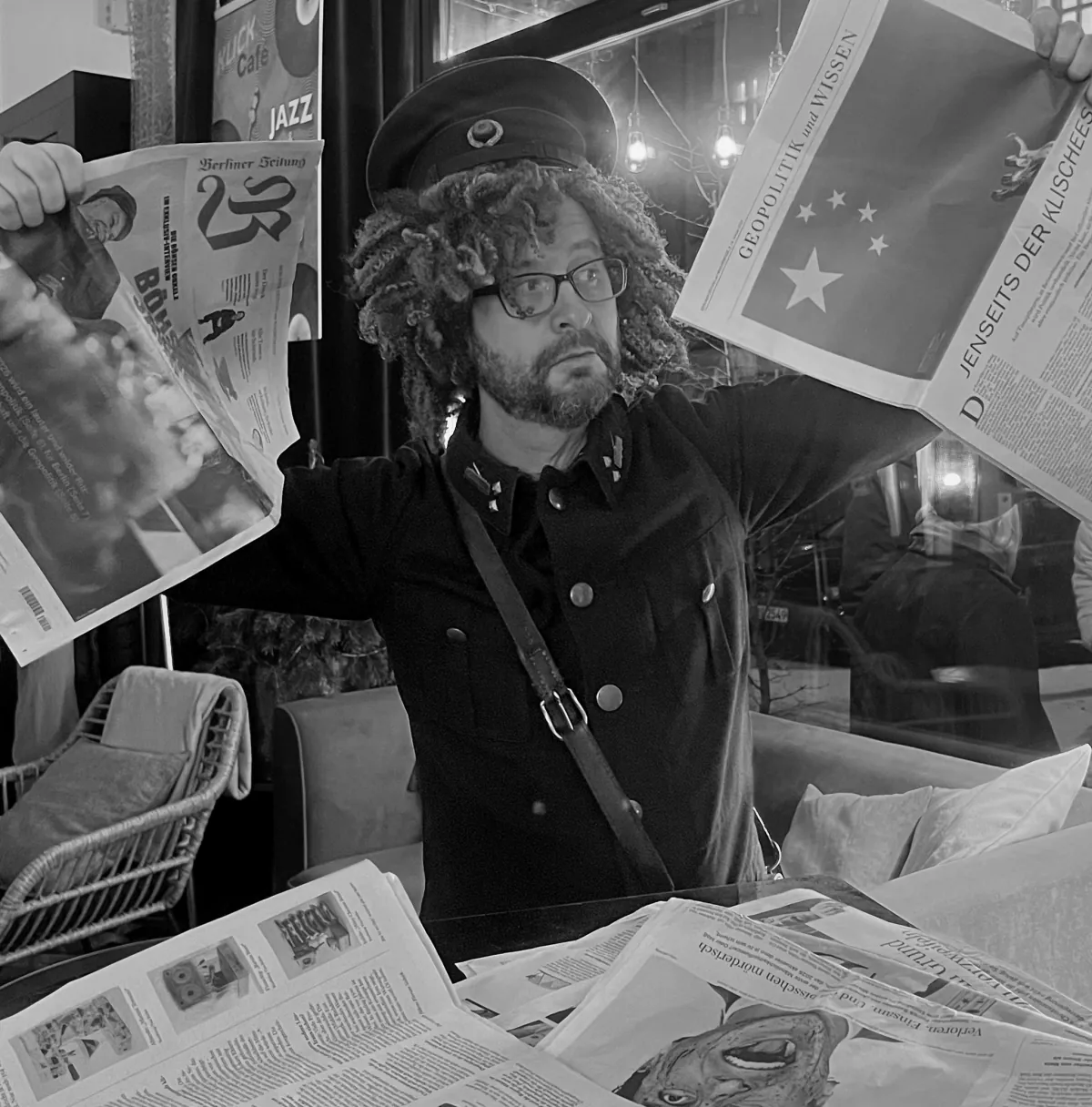 Agnes holds open newspapers at Klick Café.